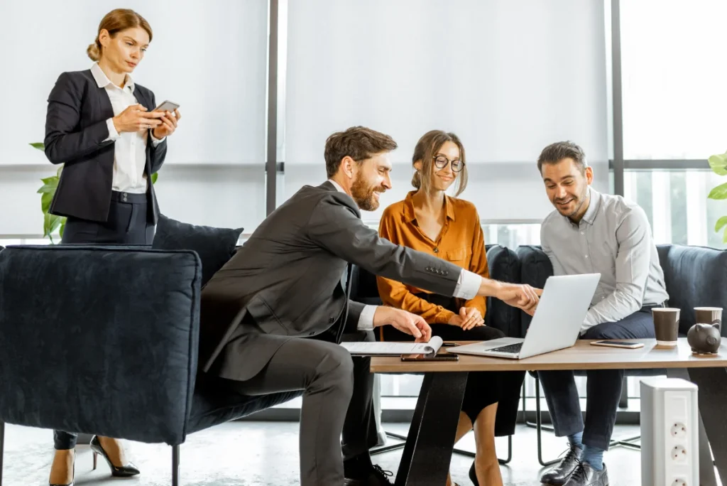 A group of market researchers happily discussing TruStrata's data analysis tools for reporting.